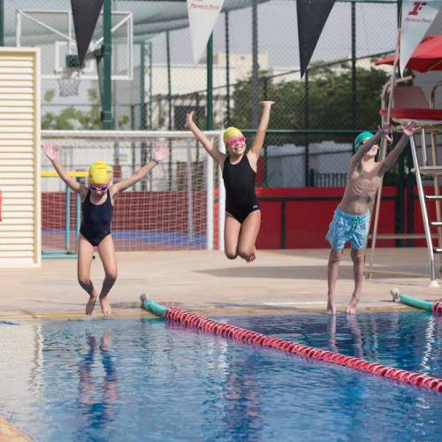 Kids jumping in a swimming pool