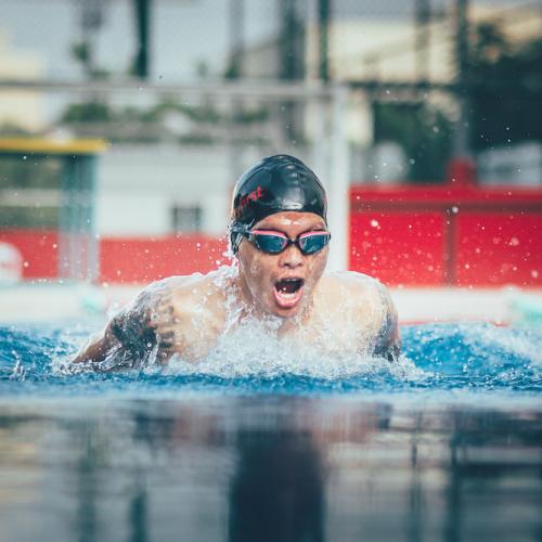 young man performing butterfly swim